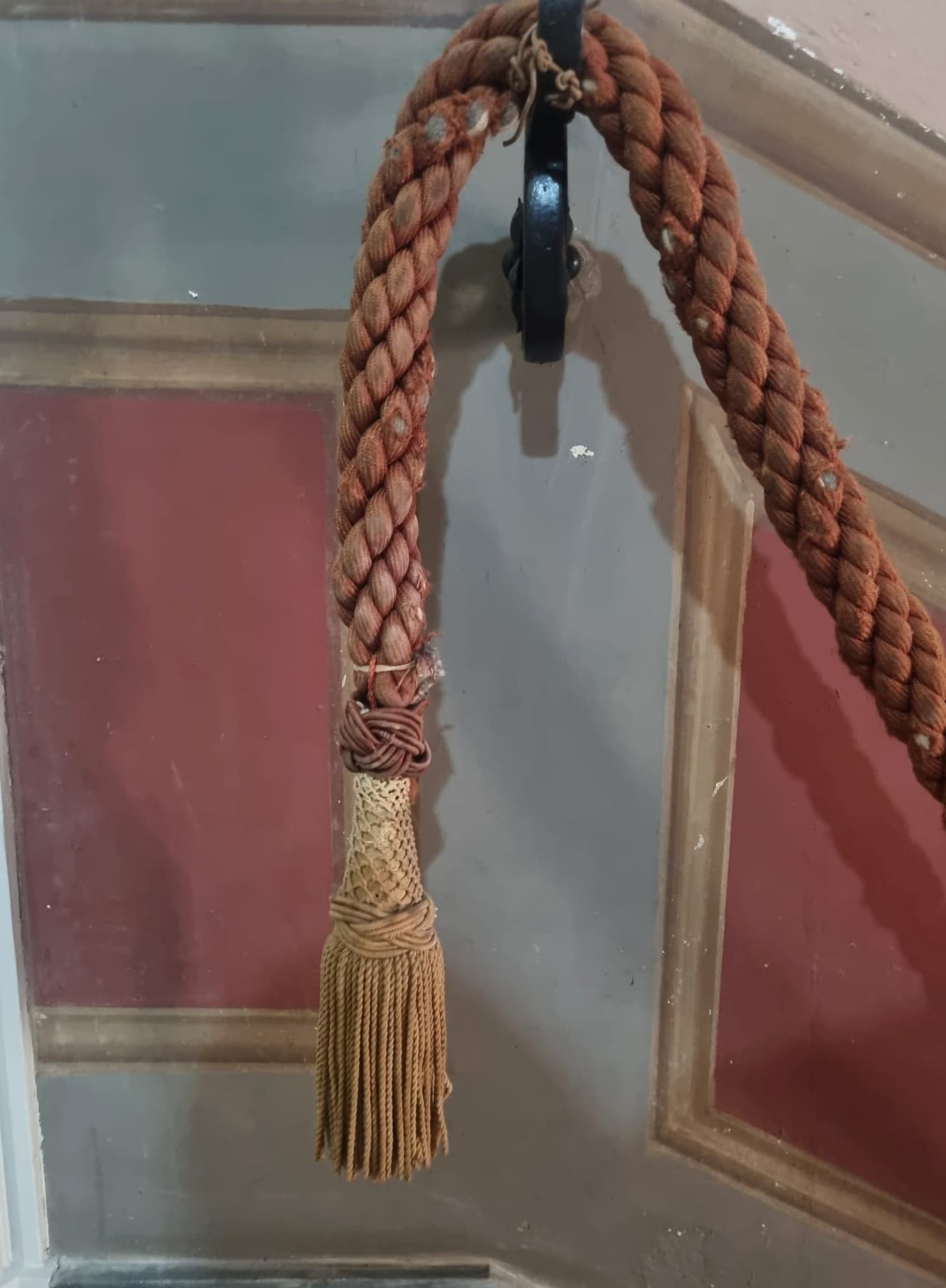 Decorative rope and tassel on a painted interior wall