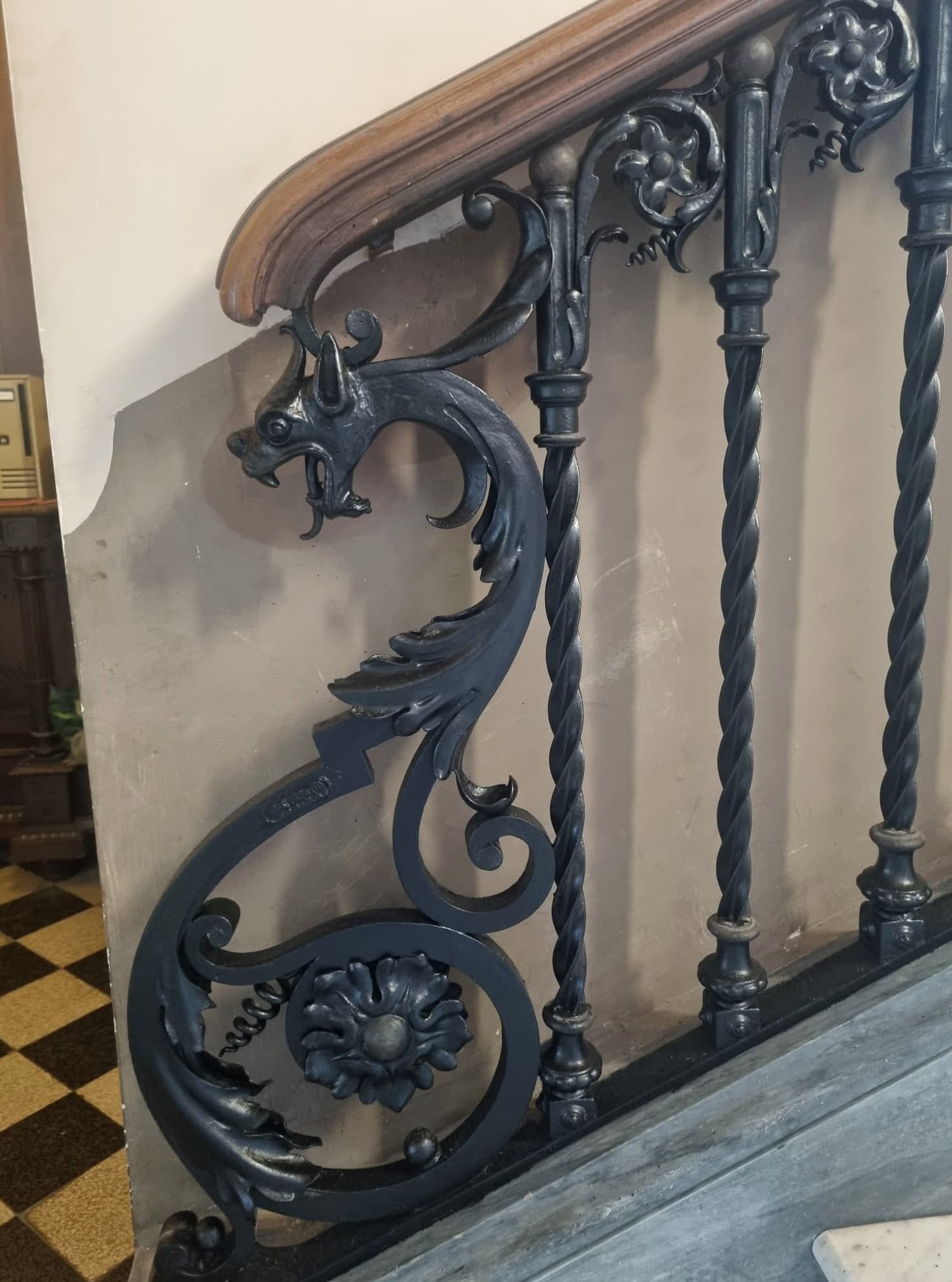 Ornate wrought-iron stair railing with a dragon motif