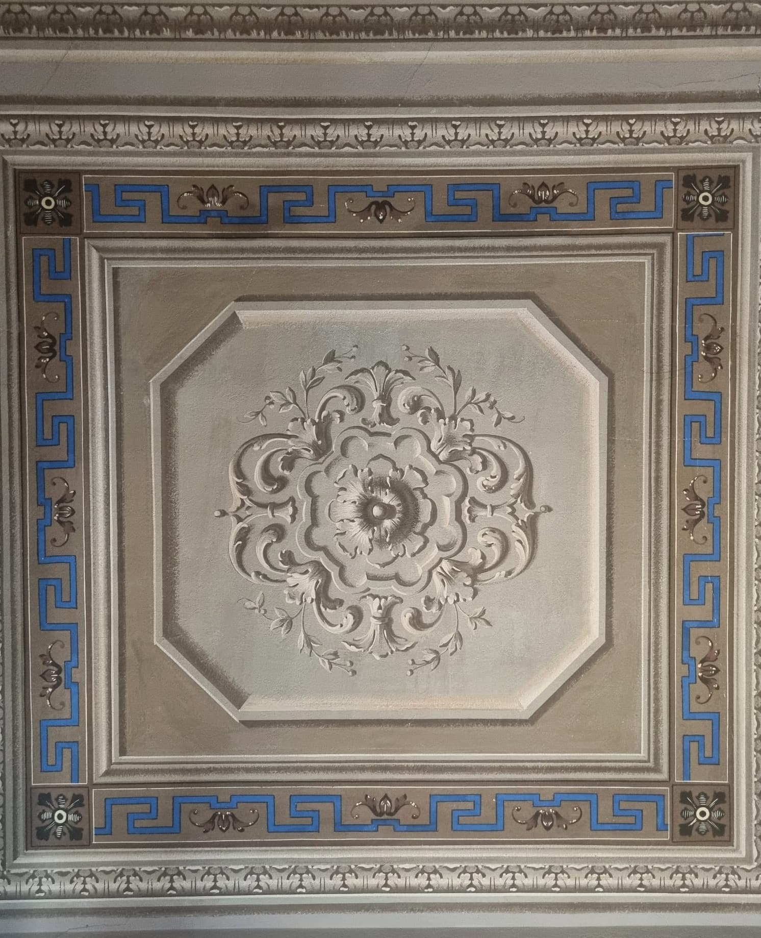 Painted ceiling panel with a Greek key border and floral medallion