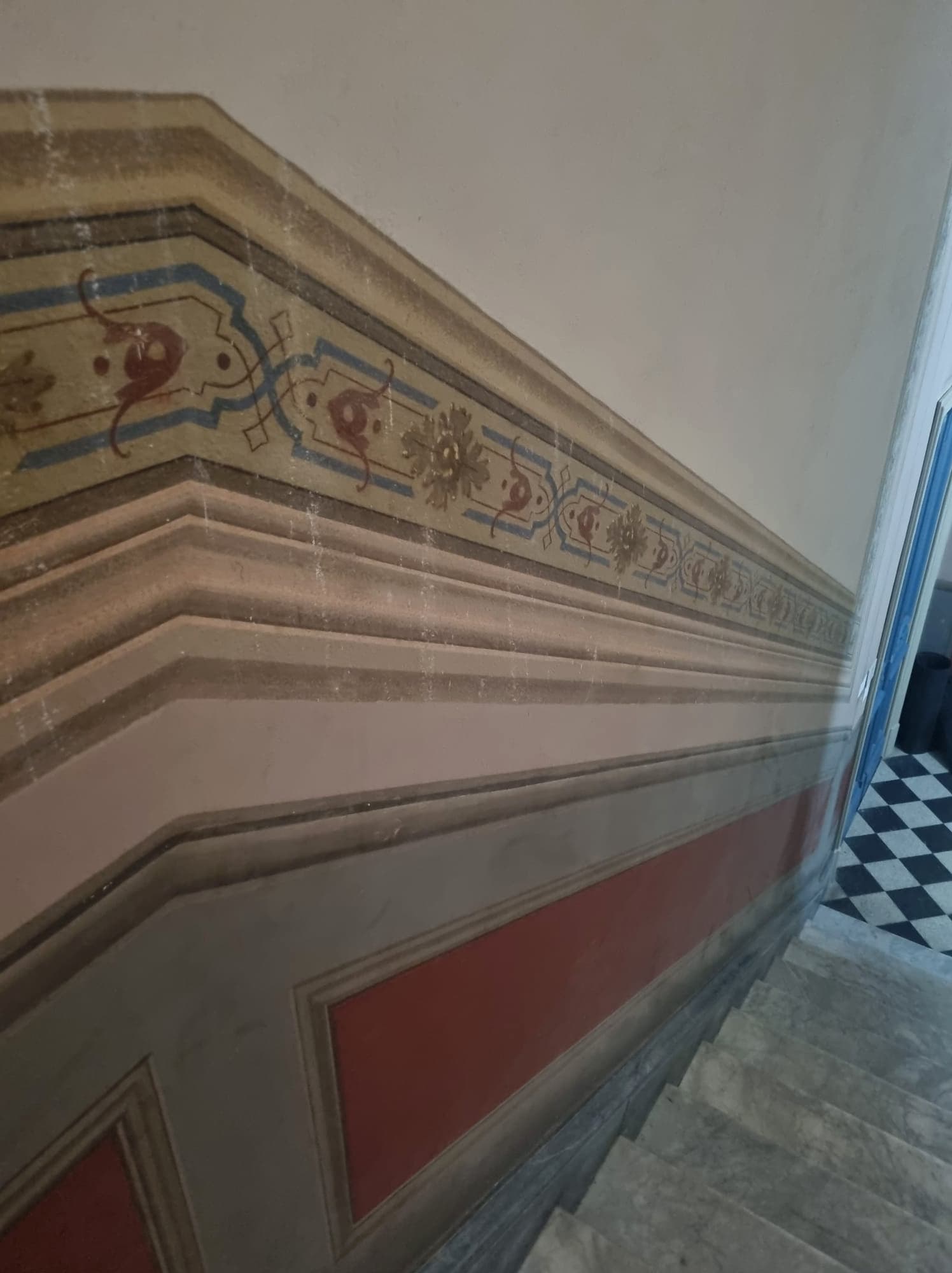 Marble staircase with historic painted wall decoration